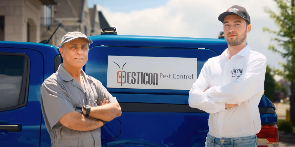 Pesticon pest control technicians standing by a company van in Langley